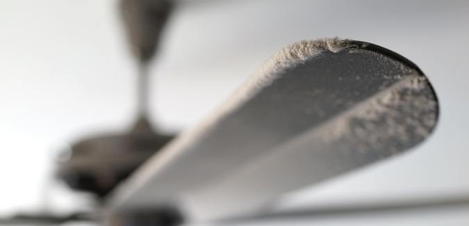 A photo of dust on a ceiling fan indoors