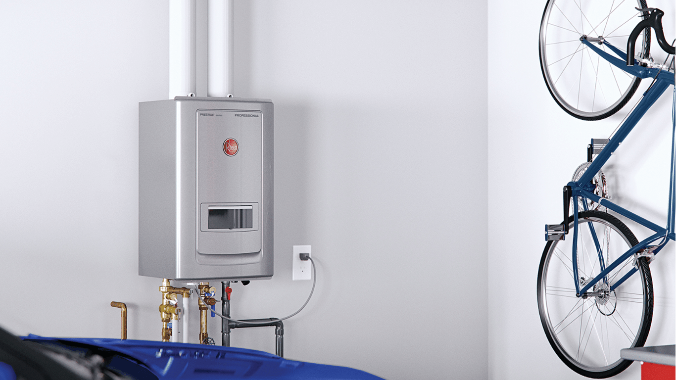 A water heating appliance attached to a grey color wall next to a bike hanging on a hook